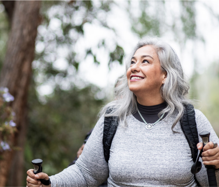 a photo of a person happily hiking a trail