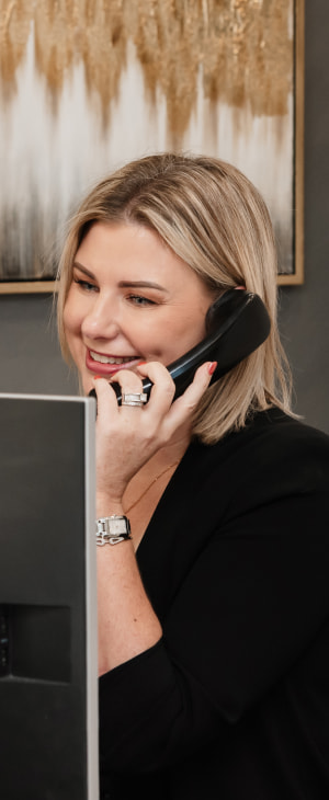 a photo of a person talking on the phone at the reception desk